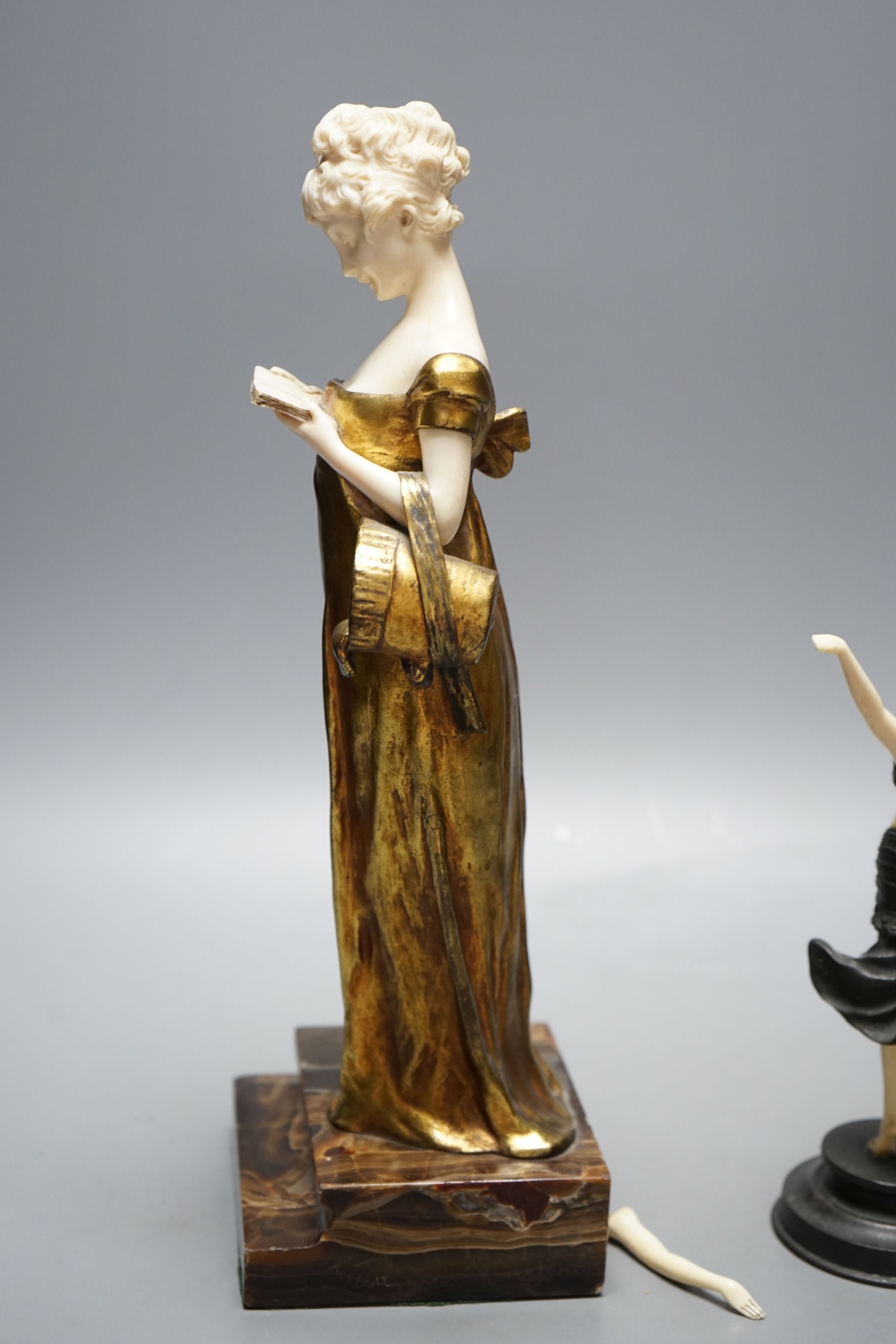 Georges Van Der Straeten, Belgian 1856-1928, An Art Deco bronze and ivory figure of a girl reading a book together with a smaller bronze and ivory figure, Tallest 31.5 cms high.
